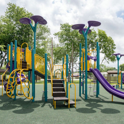 two level playground with yellow railings and purple slide